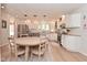 Eat-in kitchen boasts granite countertops, white cabinets, stainless steel appliances, and a sunny breakfast area at 4585 Abbey Dr, Carmel, IN 46033