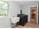 Bright laundry area with modern washer and dryer and a sink near a window with a view of the backyard at 4585 Abbey Dr, Carmel, IN 46033