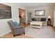 Cozy living room with neutral tones, stylish decor, hardwood floors and plenty of natural light at 4585 Abbey Dr, Carmel, IN 46033