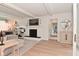 Cozy living room featuring a white painted brick fireplace and built-in shelving at 4585 Abbey Dr, Carmel, IN 46033