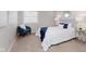A comfy bedroom featuring a cushioned headboard, stylish decor, and a plush chair near a window at 49 Druid Hill Ct # 0, Carmel, IN 46032