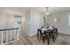 Bright dining room includes a modern light fixture and staircase leading to the upper level at 49 Druid Hill Ct # 0, Carmel, IN 46032