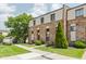 Brick townhome on well-maintained lawn with sidewalk and large tree on the side at 49 Druid Hill Ct # 0, Carmel, IN 46032