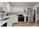 Bright kitchen features white cabinets, quartz countertops, stainless steel appliances, and light grey backsplash at 49 Druid Hill Ct # 0, Carmel, IN 46032