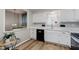 Bright kitchen features white cabinets, quartz countertops, stainless steel appliances, and light grey backsplash at 49 Druid Hill Ct # 0, Carmel, IN 46032