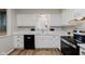 Bright kitchen features white cabinets, quartz countertops, stainless steel appliances, and light grey backsplash at 49 Druid Hill Ct # 0, Carmel, IN 46032