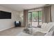 Spacious living room features neutral carpet, modern decor, and sliding glass doors to the backyard at 49 Druid Hill Ct # 0, Carmel, IN 46032