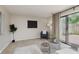 Spacious living room features neutral carpet, modern decor, and sliding glass doors to the backyard at 49 Druid Hill Ct # 0, Carmel, IN 46032