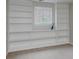 Bright living room features custom built-in shelving and large window at 49 Druid Hill Ct # 0, Carmel, IN 46032