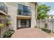 Back of home features sliding glass door to balcony and patio with flowers at 49 Druid Hill Ct # 0, Carmel, IN 46032