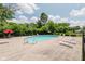 Inviting community pool surrounded by lounge chairs and lush greenery under a bright sky at 49 Druid Hill Ct # 0, Carmel, IN 46032