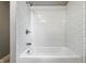 Clean bathroom featuring a white subway tile shower and bathtub with chrome fixtures at 5170 Mt Pleasant N St, Greenwood, IN 46142