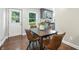 Dining area with hardwood floors, gray cabinets, and backyard views at 5170 Mt Pleasant N St, Greenwood, IN 46142