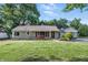 Charming single-story home featuring stone facade, flower beds, and well-manicured lawn at 5170 Mt Pleasant N St, Greenwood, IN 46142