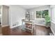 Bright office with a hardwood floor features a large window, a work table, a chair, and a decorative shelf at 5170 Mt Pleasant N St, Greenwood, IN 46142