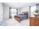 Cozy bedroom featuring plush carpet, two windows, and stylish blue bedding at 5294 Lndg Pl Ln, Noblesville, IN 46062