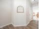 Hallway view with a decorative wall hanging; bedroom visible from hall at 5294 Lndg Pl Ln, Noblesville, IN 46062