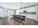 Bright kitchen features a large island with bar seating, stainless appliances, and sleek countertops at 5294 Lndg Pl Ln, Noblesville, IN 46062