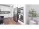 Stainless refrigerator and microwave appliances complete with a view of the kitchen space at 5294 Lndg Pl Ln, Noblesville, IN 46062
