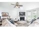 Cozy living room with fireplace, TV, ceiling fan, and comfortable seating arrangements at 5294 Lndg Pl Ln, Noblesville, IN 46062
