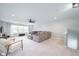 Spacious living room featuring plush carpet, a ceiling fan, and lots of natural light at 5294 Lndg Pl Ln, Noblesville, IN 46062