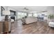 Open-concept living room with fireplace, TV, wood floors, and lots of seating at 5294 Lndg Pl Ln, Noblesville, IN 46062