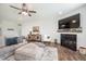 Well-decorated living room featuring a fireplace, TV, and stylish furniture at 5294 Lndg Pl Ln, Noblesville, IN 46062