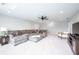 Spacious living room with plush sectional sofa, carpet and a ceiling fan at 5294 Lndg Pl Ln, Noblesville, IN 46062