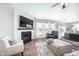 Living room with fireplace, television, shiplap accent wall, and modern furniture at 5294 Lndg Pl Ln, Noblesville, IN 46062