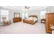 Spacious primary bedroom with ceiling fan, tray ceiling, lots of natural light, and wood furniture at 5294 Lndg Pl Ln, Noblesville, IN 46062