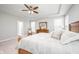 Bright primary bedroom features plush carpet, tray ceiling, ceiling fan, and cozy decor at 5294 Lndg Pl Ln, Noblesville, IN 46062