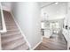 Carpeted staircase leading to an open-concept living area with a modern kitchen at 5294 Lndg Pl Ln, Noblesville, IN 46062