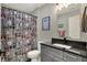 This bathroom features an updated vanity with modern fixtures and a unique dog-themed shower curtain at 5386 W 1100, Fountaintown, IN 46130