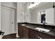 Bathroom vanity with a double sink, granite countertop, and a view of the bath tub and toilet at 5386 W 1100, Fountaintown, IN 46130