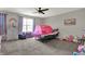 This bedroom features a large window, ceiling fan, and carpet flooring, ideal for children or guests at 5386 W 1100, Fountaintown, IN 46130