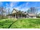Spacious home with a large, covered porch and an adjacent two-car garage on a sunny day at 5386 W 1100, Fountaintown, IN 46130