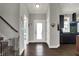 Open foyer with hardwood floors, with views of the kitchen and the staircase at 5386 W 1100, Fountaintown, IN 46130