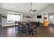 Living room with a wood dining table, leather furniture, and bright natural light from large windows at 5386 W 1100, Fountaintown, IN 46130