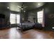 Spacious main bedroom with dark walls, wood-look floors, large windows, and canopy bed at 5386 W 1100, Fountaintown, IN 46130