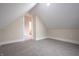 Finished attic room with neutral walls and carpeted floors, perfect for extra space at 5511 E University Ave, Indianapolis, IN 46219