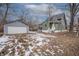 Backyard featuring a detached garage and ample yard space with a green house at 5511 E University Ave, Indianapolis, IN 46219