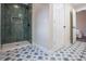 Bathroom features a sleek walk-in shower with emerald tiles and patterned floor tiles at 5511 E University Ave, Indianapolis, IN 46219