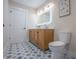 Bathroom featuring a stylish vanity, patterned floor tiles, contemporary decor, and a toilet at 5511 E University Ave, Indianapolis, IN 46219