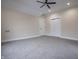 Bedroom features a ceiling fan, neutral walls, and multiple closets for ample storage at 5511 E University Ave, Indianapolis, IN 46219