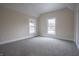 Cozy bedroom with a neutral palette and two large windows, providing ample natural light at 5511 E University Ave, Indianapolis, IN 46219