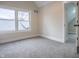 A bright bedroom with neutral walls, carpeted floors, and a view into another room at 5511 E University Ave, Indianapolis, IN 46219