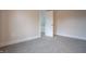Neutral bedroom with carpeted floors and a doorway into another room at 5511 E University Ave, Indianapolis, IN 46219