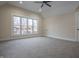 Bright bedroom with large windows, ceiling fan and neutral color scheme at 5511 E University Ave, Indianapolis, IN 46219