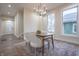 Bright dining room features a modern chandelier, large windows, and hardwood-style floors at 5511 E University Ave, Indianapolis, IN 46219