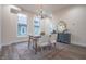 Bright dining room features a modern chandelier, a decorative mirror, and a large window overlooking the neighborhood at 5511 E University Ave, Indianapolis, IN 46219